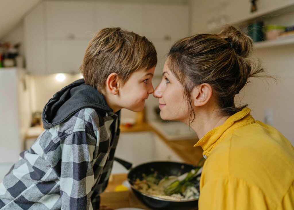 Boy and mom smiling touching noses